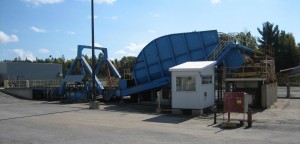 Back-on, Extended-arm Dumper with Above-ground Receiving Hopper